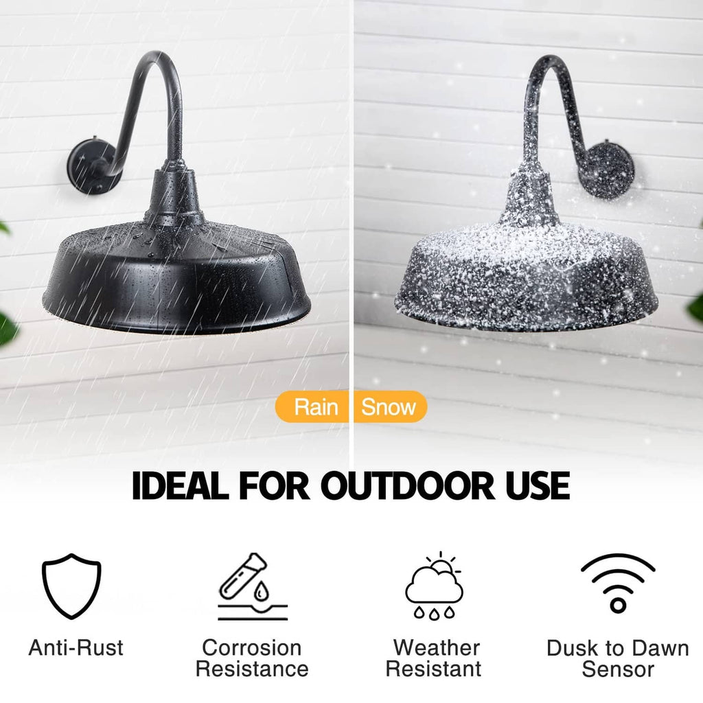 Black outdoor barn light with gooseneck arm and domed shade shown in rain and snow