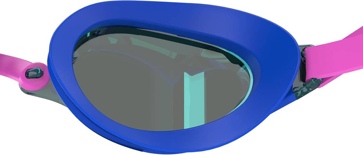 Swim goggles close-up of one dark tinted lens with blue frame and pink strap
