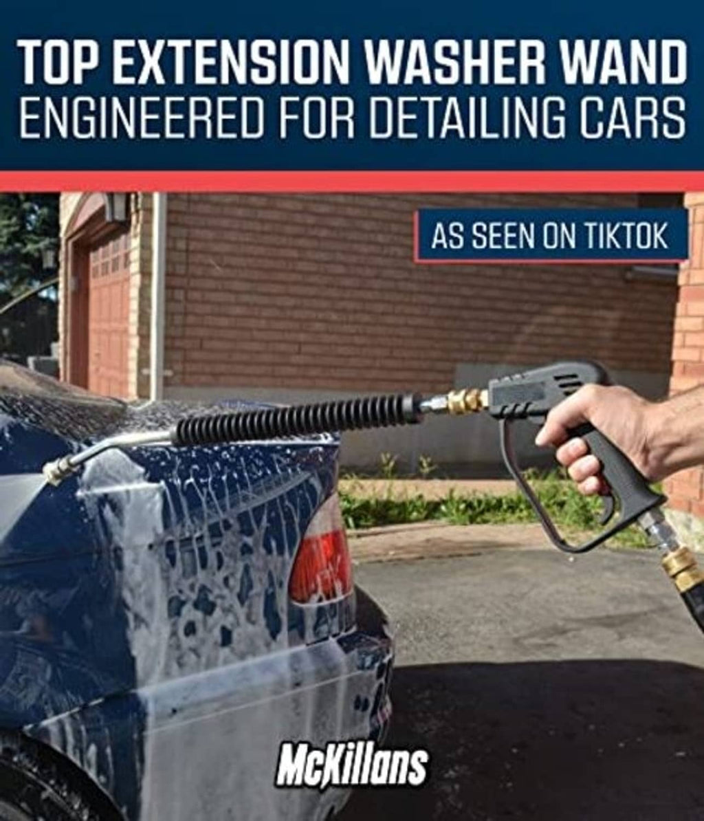 Curved pressure washer extension wand with brass fittings held at car rear