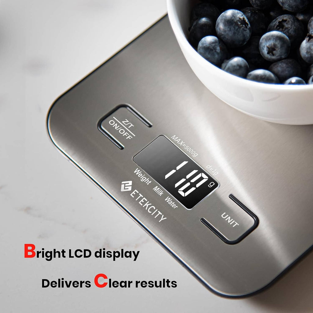 Digital kitchen scale close-up with LCD showing weight and control buttons