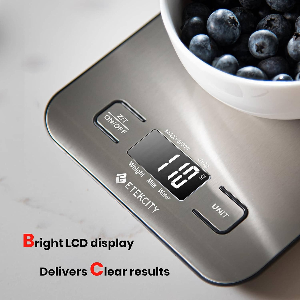 Digital kitchen scale close-up with LCD showing weight and control buttons