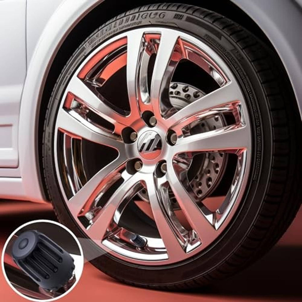 Black ribbed TPMS valve stem cap pictured on a chrome car wheel