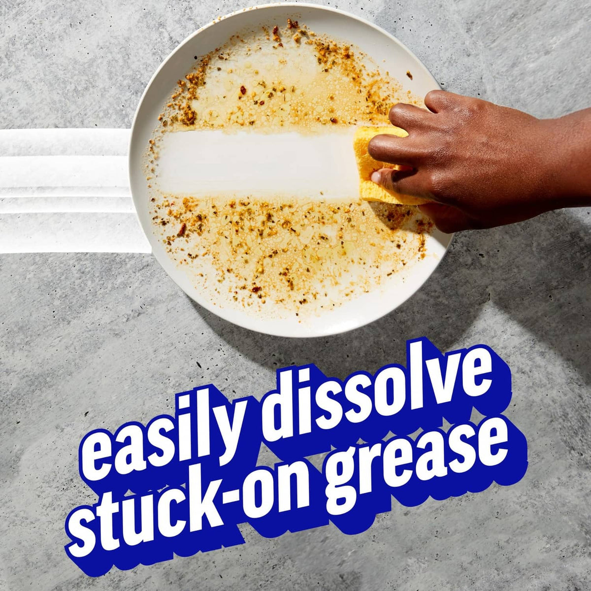 Foamy plate being scrubbed by hand, removing stuck-on food residue