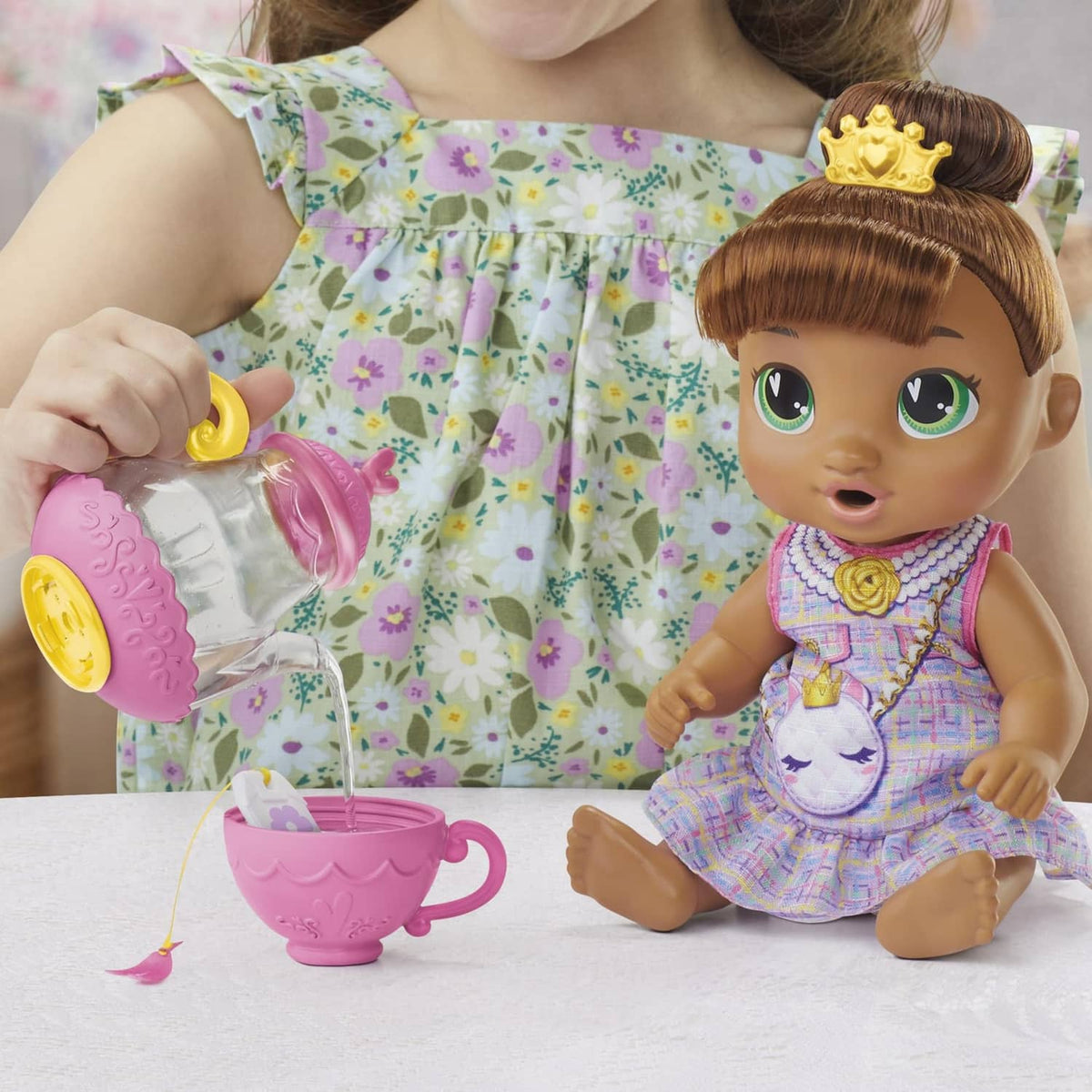 Sophia Sparkle doll with purple unicorn dress and pink teapot accessory on table