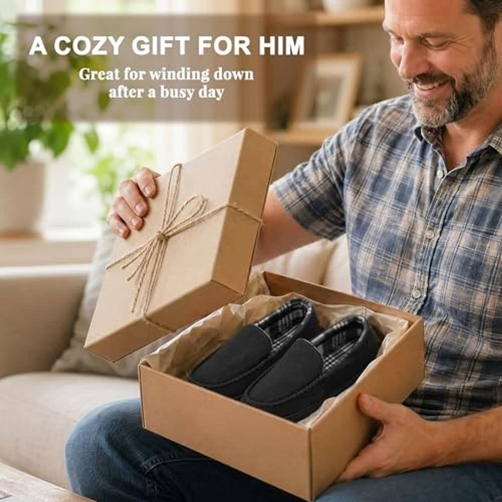 Men holding a box of black moccasin slippers; slip-on design with rubber soles.