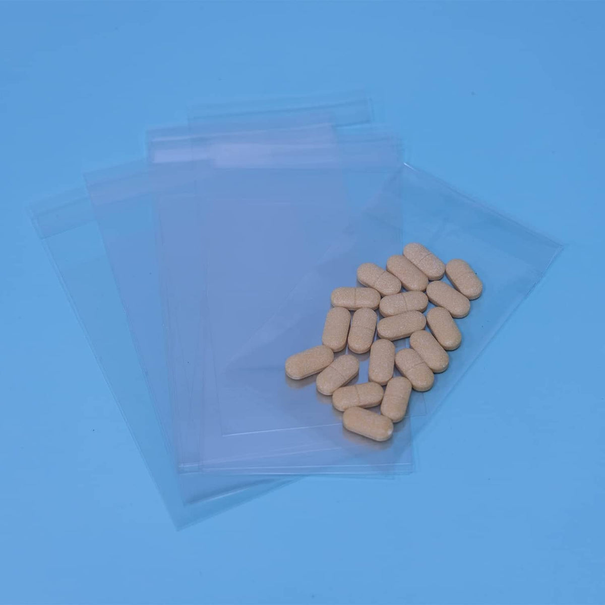 Clear self-sealing cellophane bag filled with beige tablets