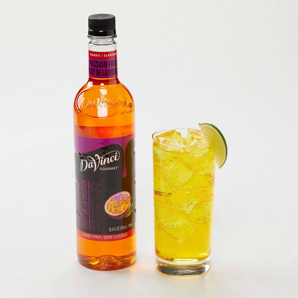 DaVinci Gourmet passion fruit syrup bottle with iced passion fruit drink in glass