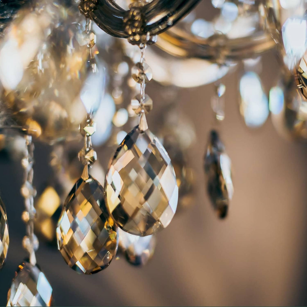 Large faceted teardrop crystal pendant drops with gold tone hardware, close view