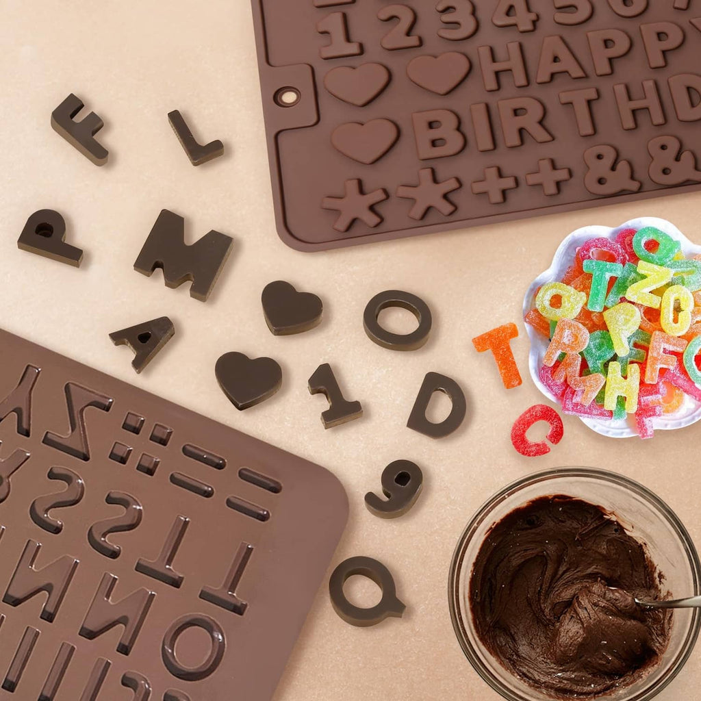 Close-up of silicone letter and number mold cavities with dark melted chocolate