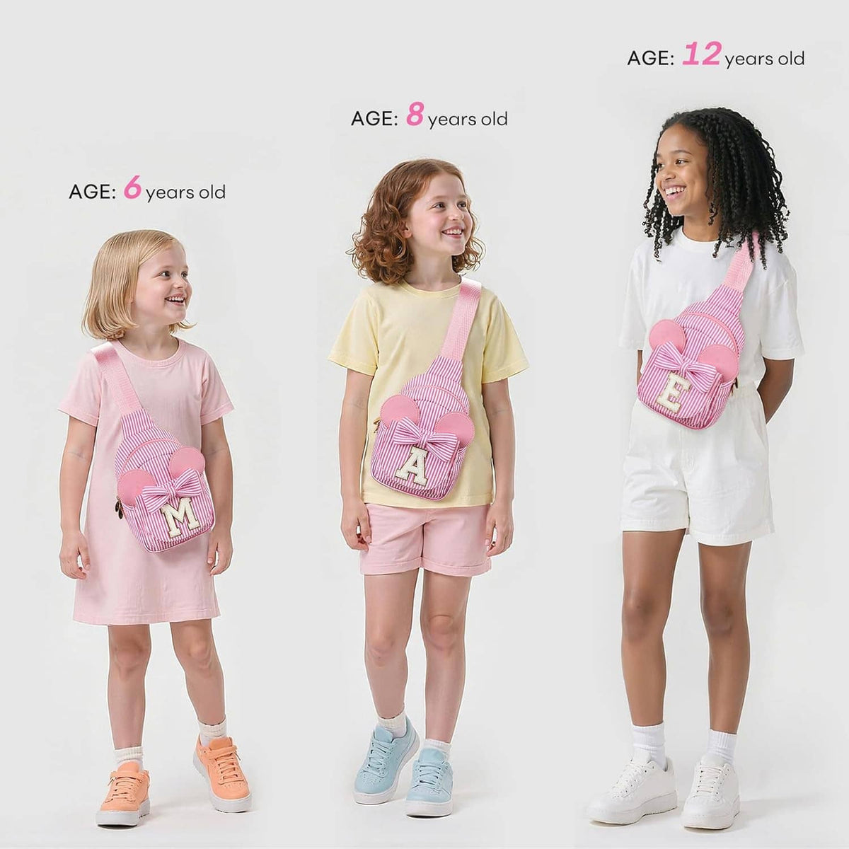 Girls wearing pink striped sling bags with bow front and letter A
