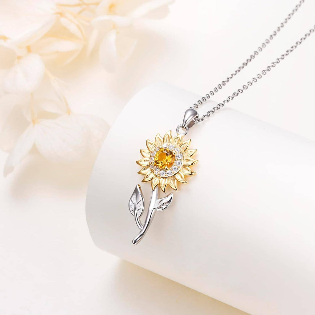 Sunflower pendant necklace with gold petals and silver leaf charm on a chain