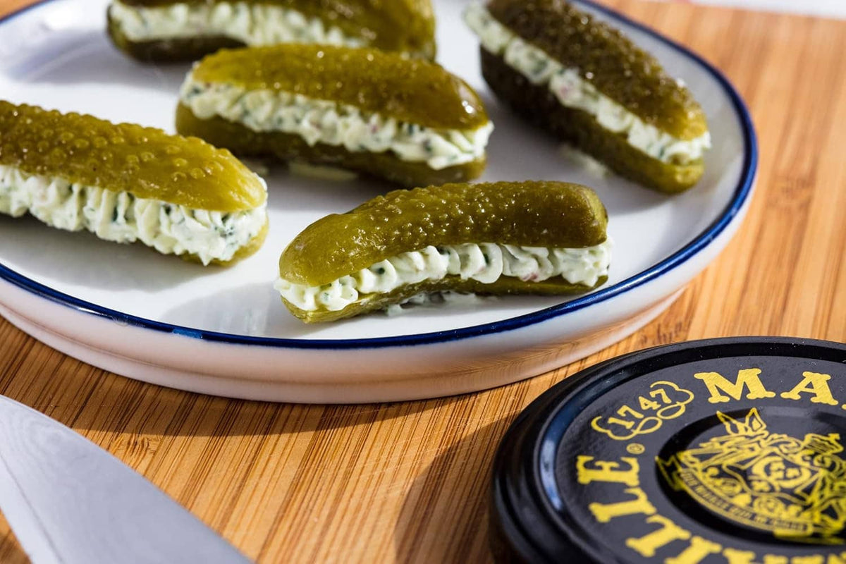 Maille cornichons: green pickle slices with cream filling on blue-rim plate