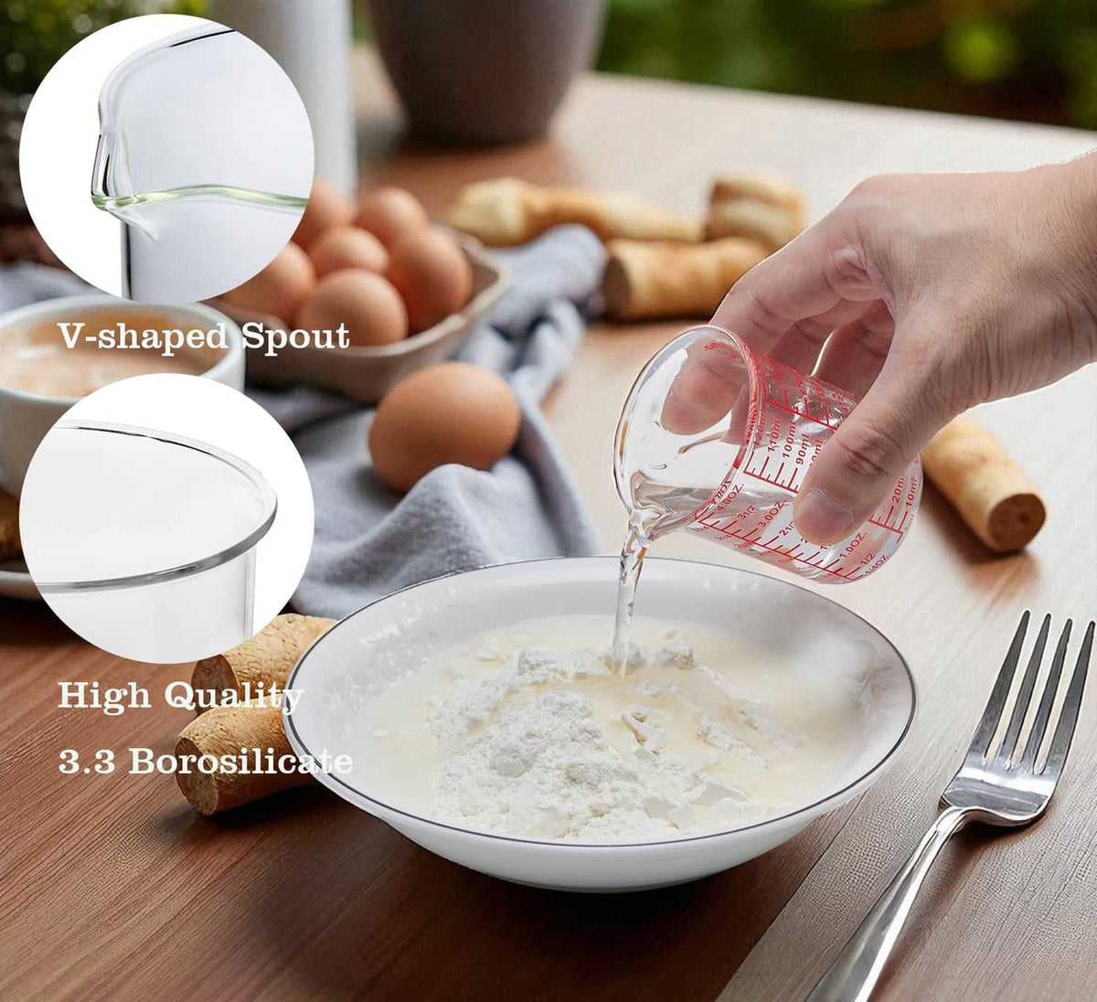 Clear V-shaped glass measuring cup with red scale markings and pour spout, 120 mL.