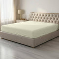 Light yellow twin fitted sheet with smooth surface and elastic edges for a snug fit