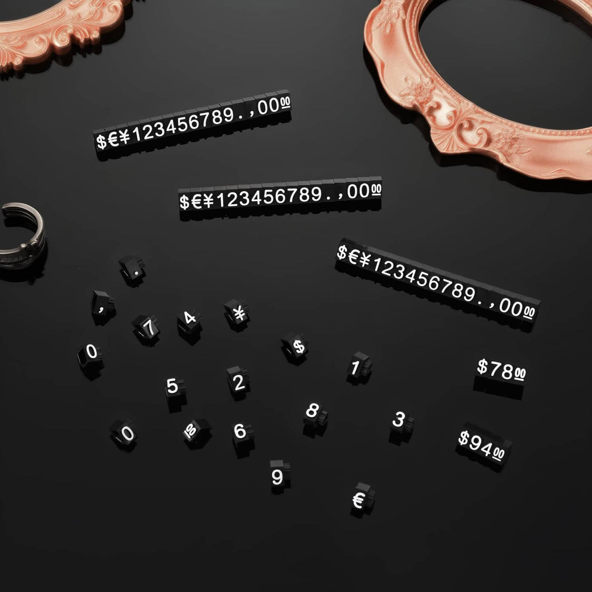 Black price display number cubes and currency tag strips arranged with $ amounts