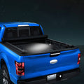 Black soft roll-up tonneau cover installed on short truck bed, rear view