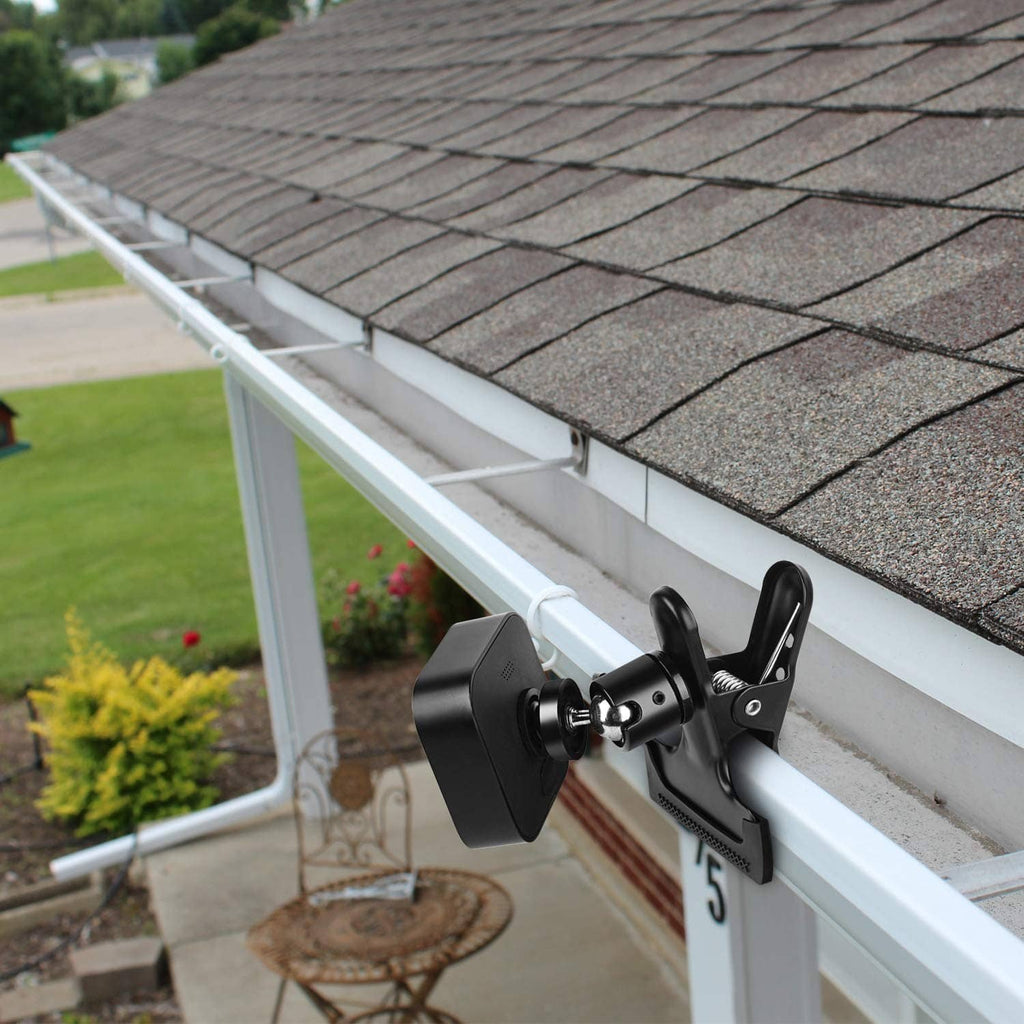 Black clip clamp mount holding a camera on a porch railing
