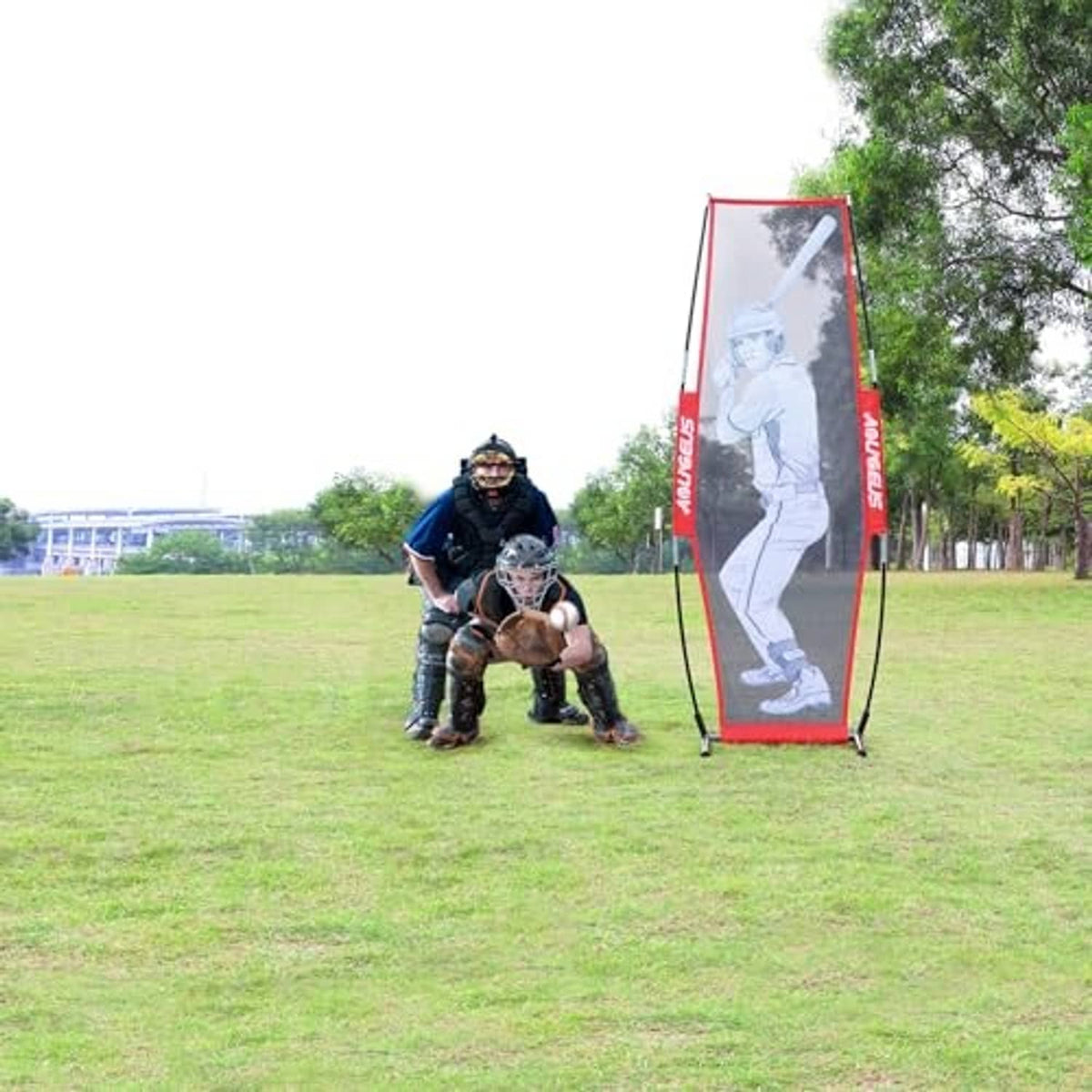 Red pitching target net with batter silhouette, set up for baseball practice