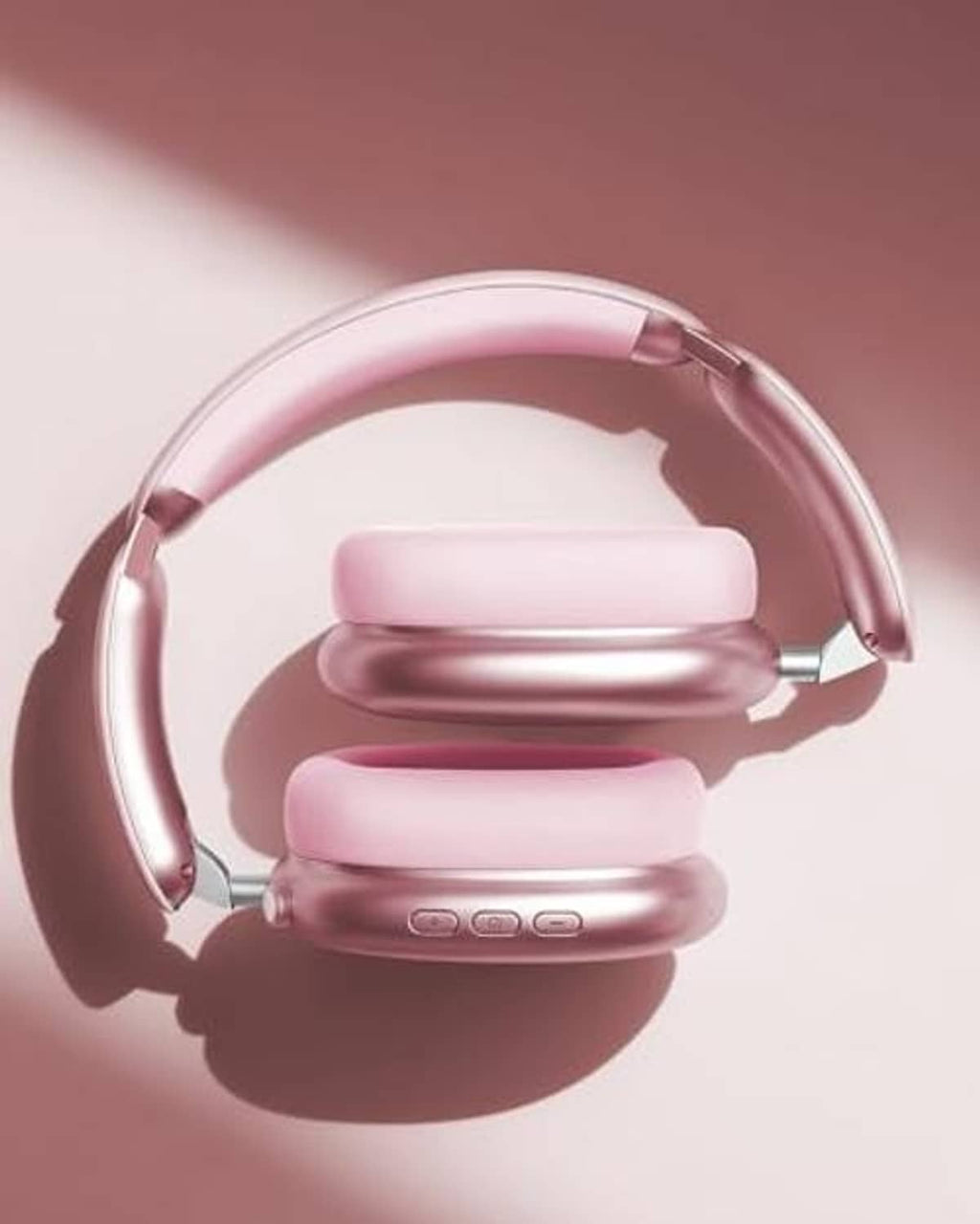 Pink over-ear wireless noise-cancelling headphones with slim earcups and hinges