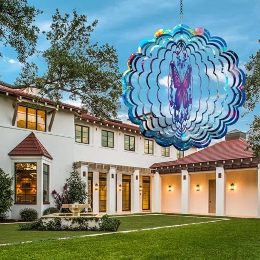 Butterfly wind spinner over lawn, blue layered metal with purple butterfly center