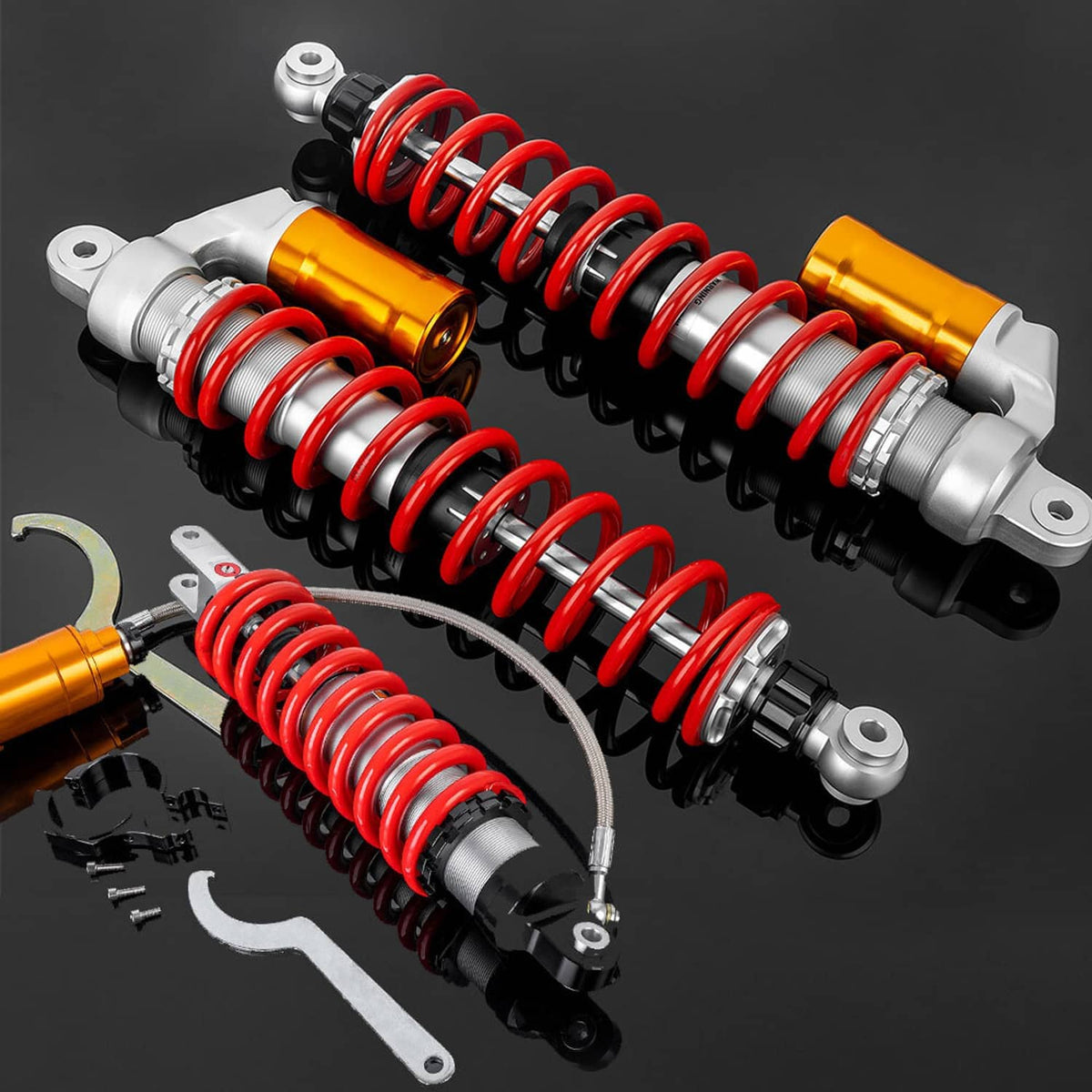 Four air shock absorbers with red coil springs, orange reservoirs, silver hardware