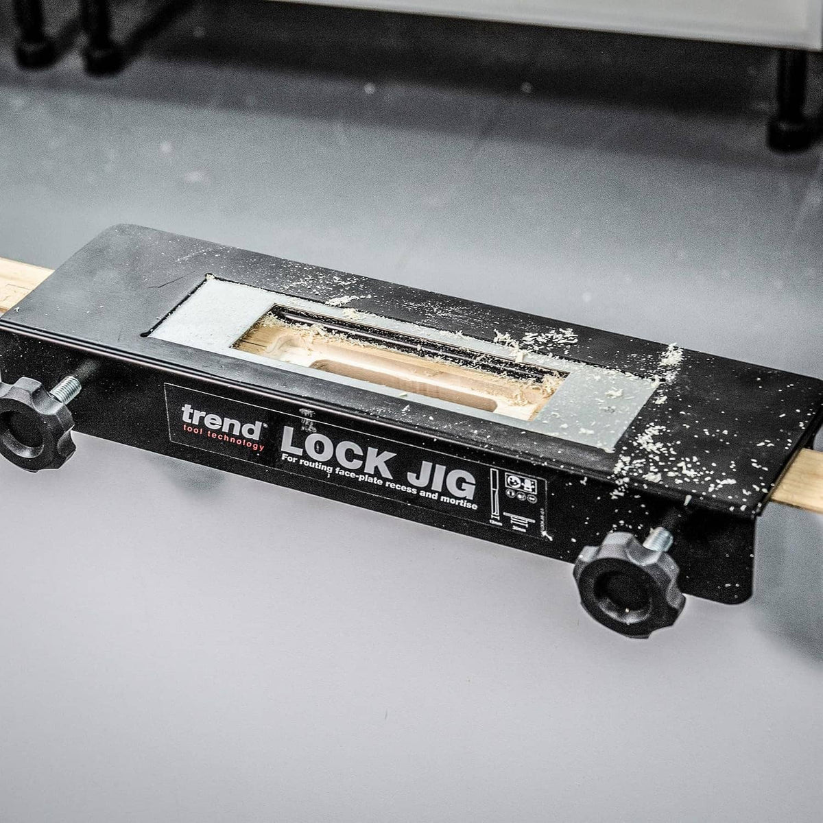 Black trend LOCK JIG with open window and dust on base, door mortising guide in use