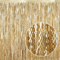 Champagne gold metallic tinsel foil curtain with wavy strands, full panel view