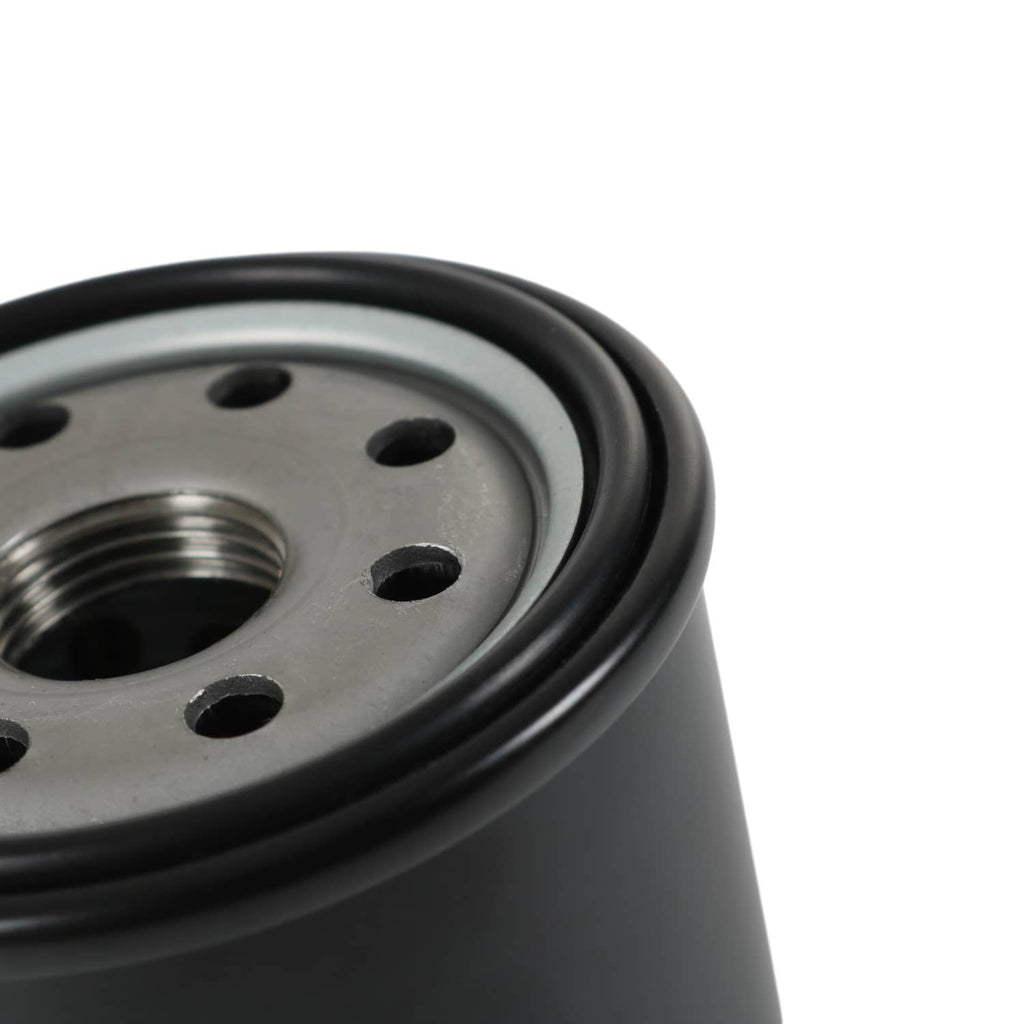 Hydraulic oil filter close-up of metal end plate with bolt holes and center port
