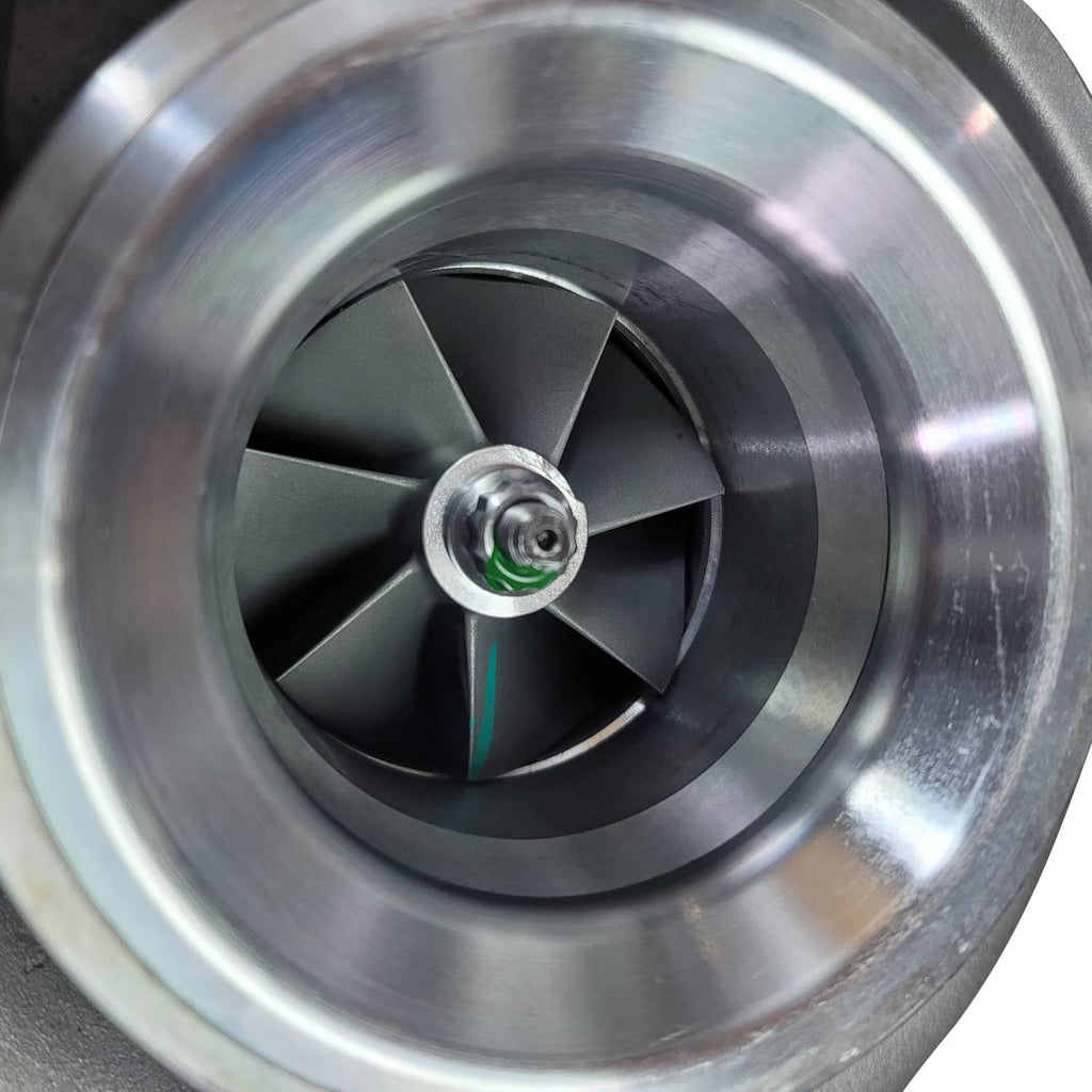 Turbocharger turbine wheel with multiple blades and central hub, close-up