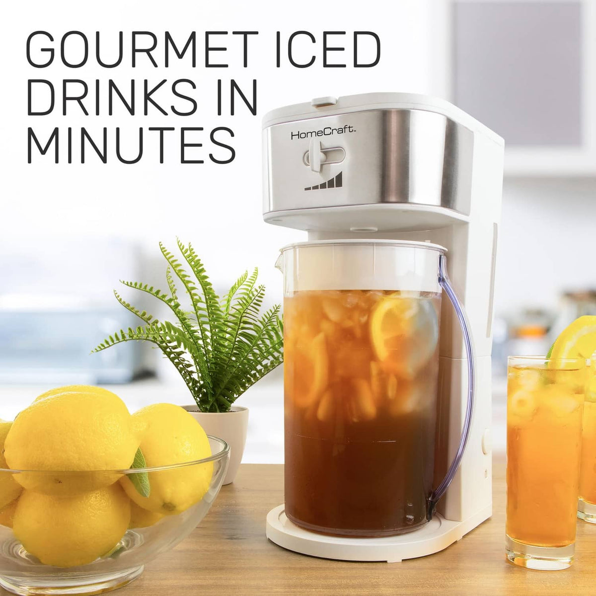 White iced tea and coffee maker with pitcher of iced tea on countertop beside lemon drink