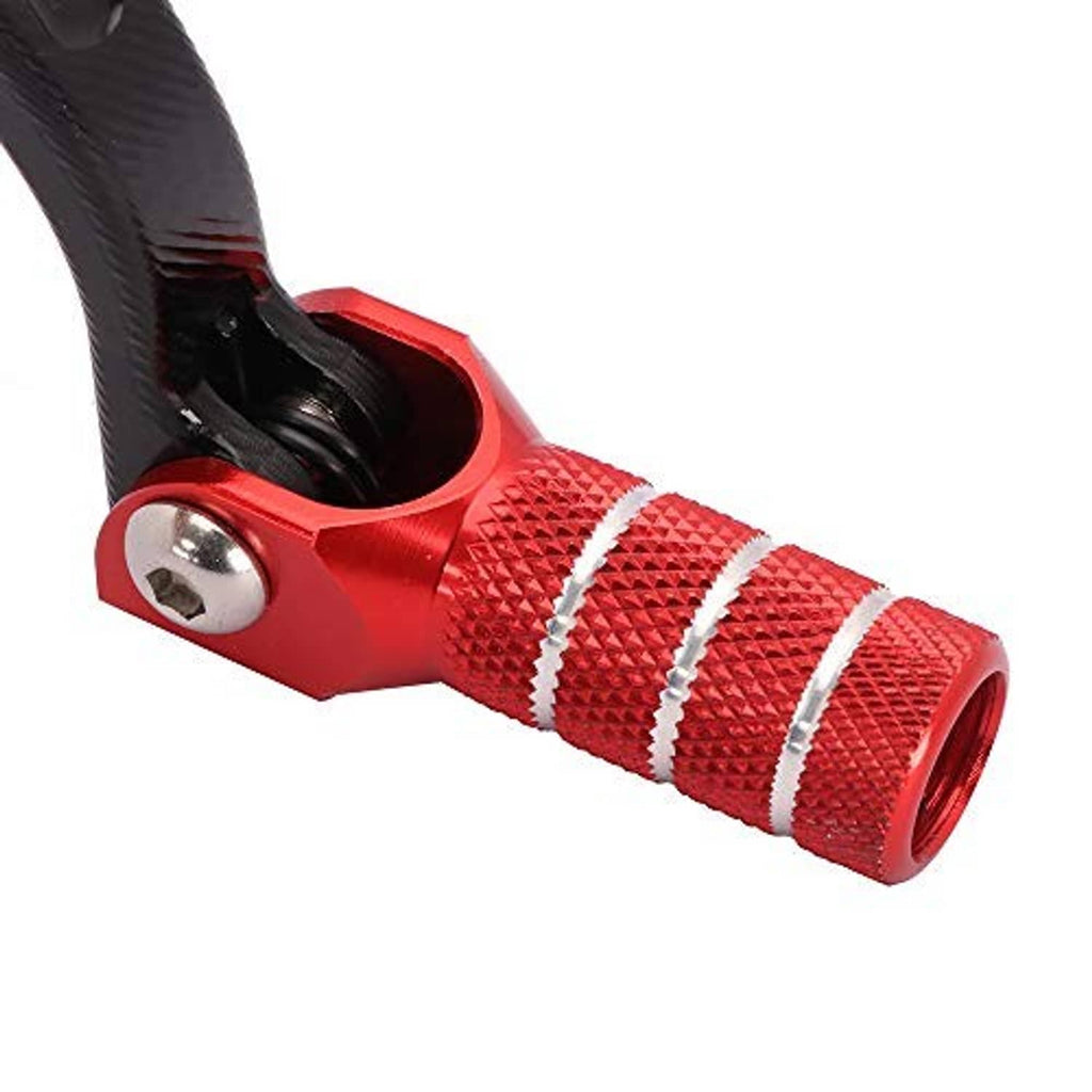 Close-up of motorcycle folding shift lever tip: red aluminum housing and striped rubber grip