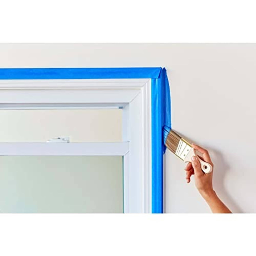 Blue painter's tape secured along a window or door frame edge