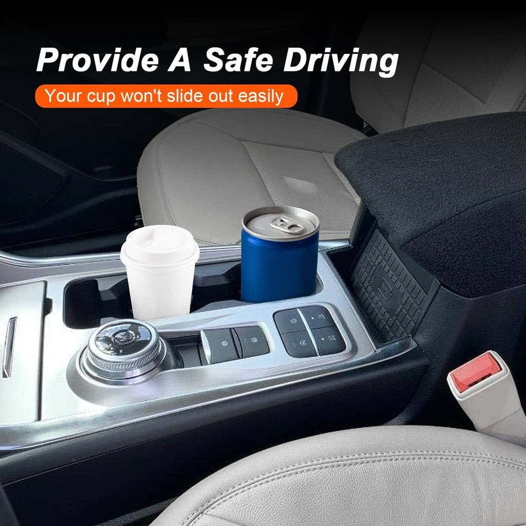 Center console cup holder with two drink slots holding a white cup and a blue can