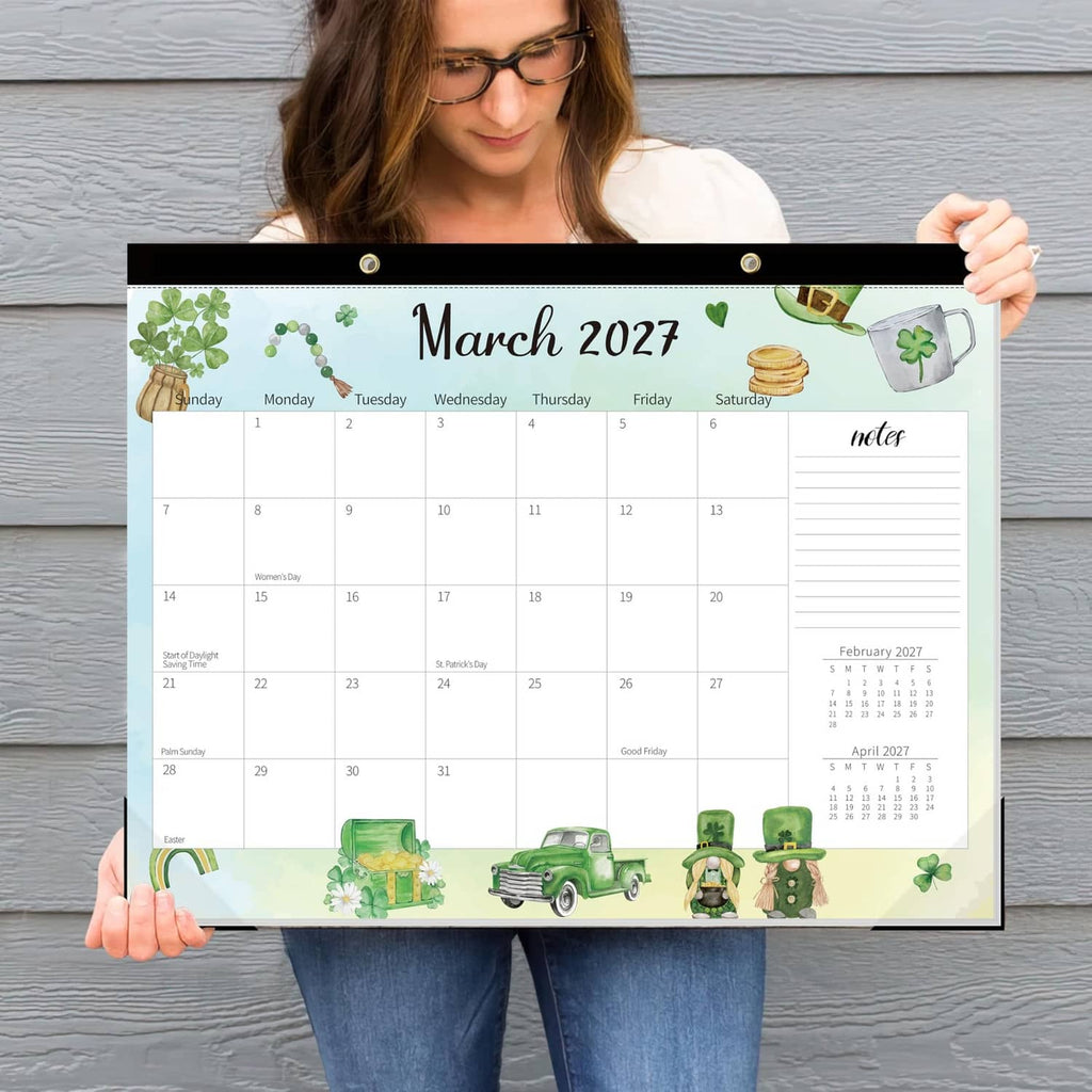 March 2027 desk calendar held up, featuring green themed border and date writing areas
