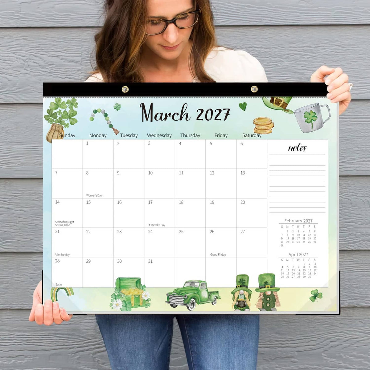 March 2027 desk calendar held up, featuring green themed border and date writing areas