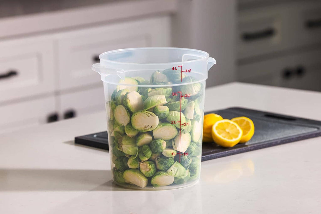 Clear plastic food storage container with lid, filled with sliced cucumbers; quart marks visible.