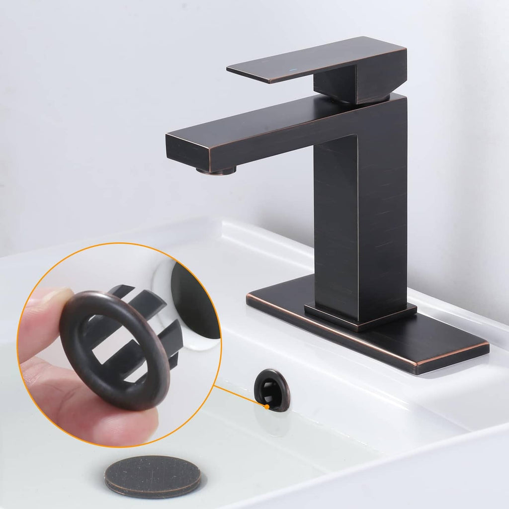 Sink overflow ring, dark round ring with center tabs shown near bathtub drain