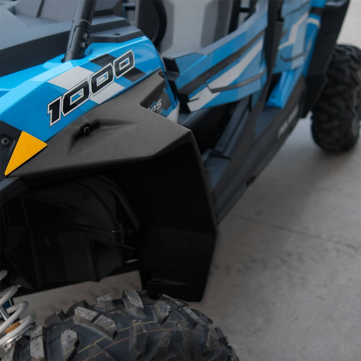 Front fender flare detail for a blue UTV, matte black with side mounting brackets