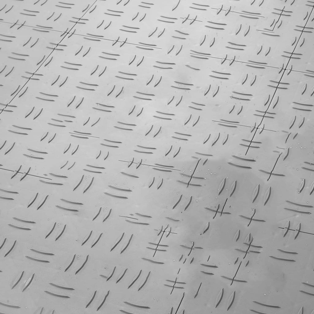 Silver garage floor tile top surface with textured anti-slip ridges and grooves