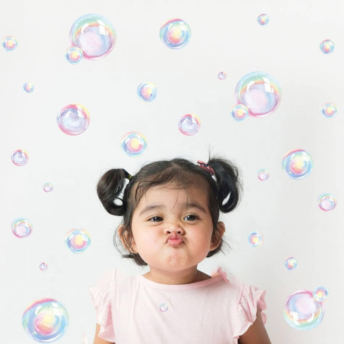 Rainbow bubble wall decals scattered across a wall with iridescent bubble circles