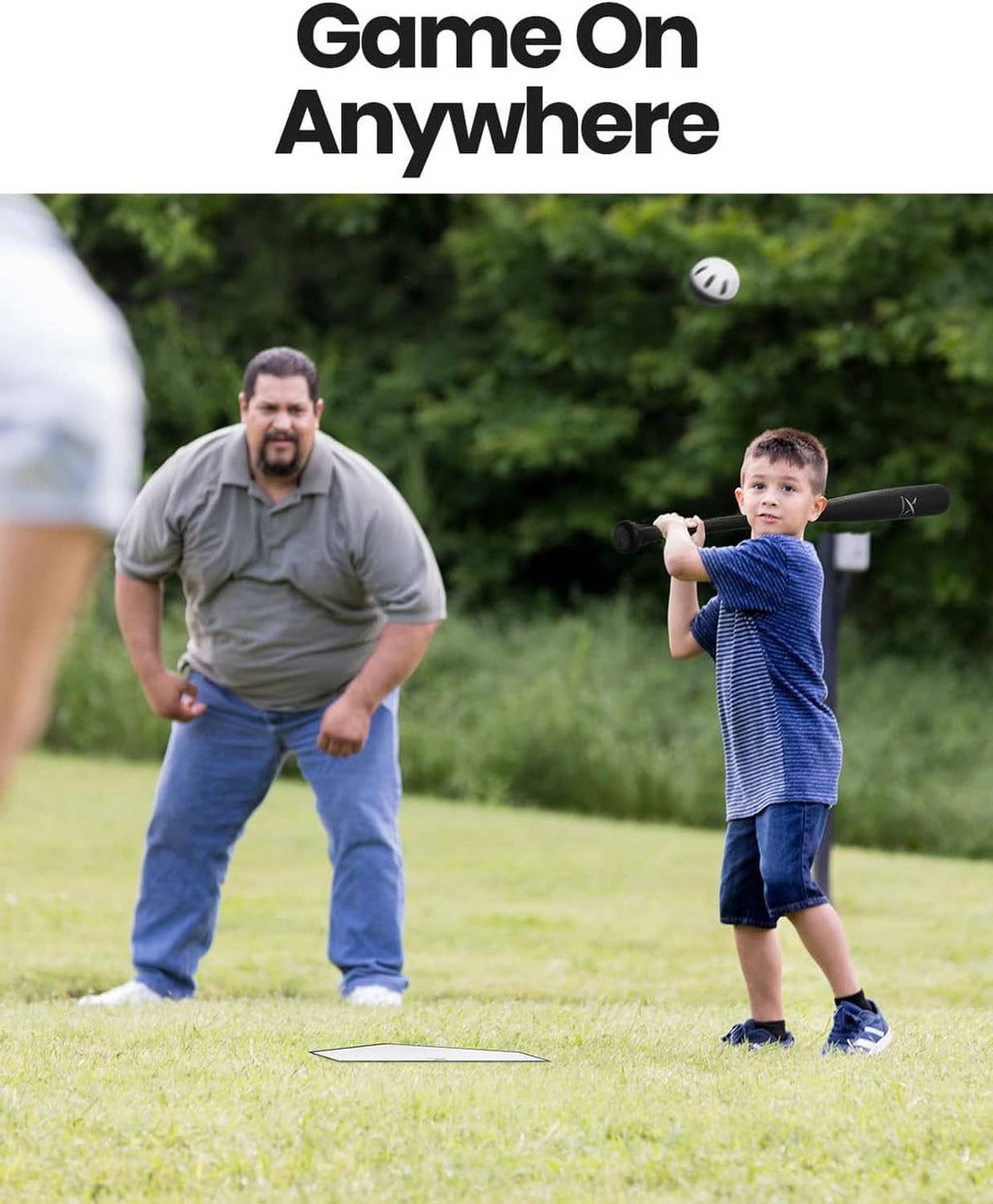 Youth swinging a black plastic baseball bat toward a perforated practice ball