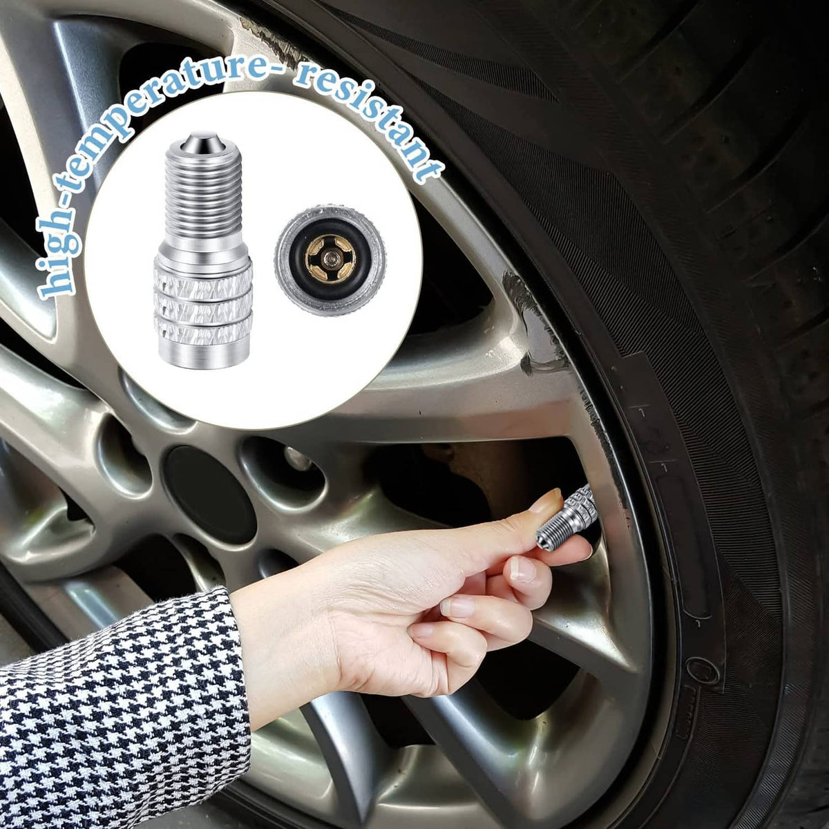 Silver metal tire valve stem cap with patterned grip, mounted on wheel valve
