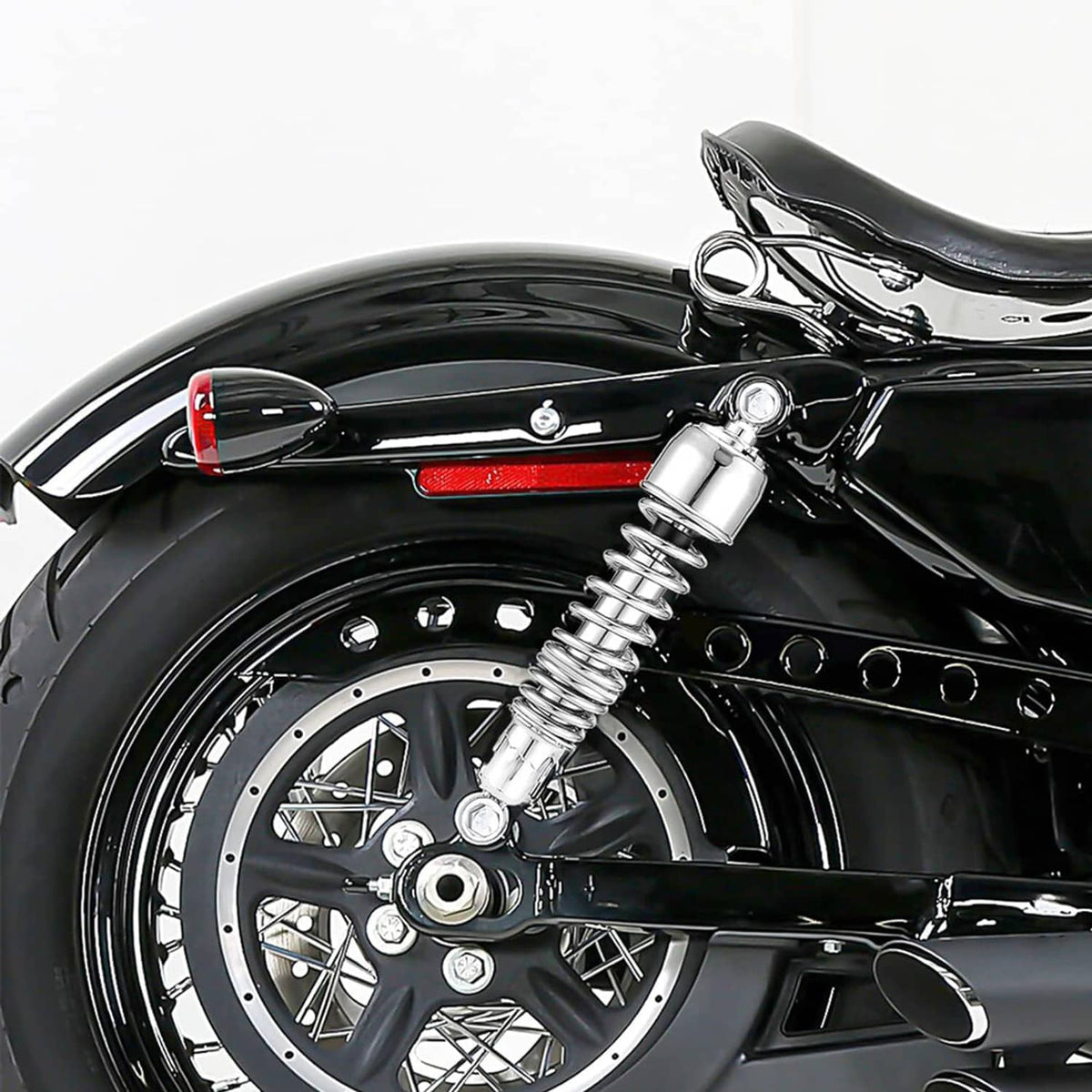 Chrome motorcycle rear shock absorber with coiled spring and mounting eyelet hardware
