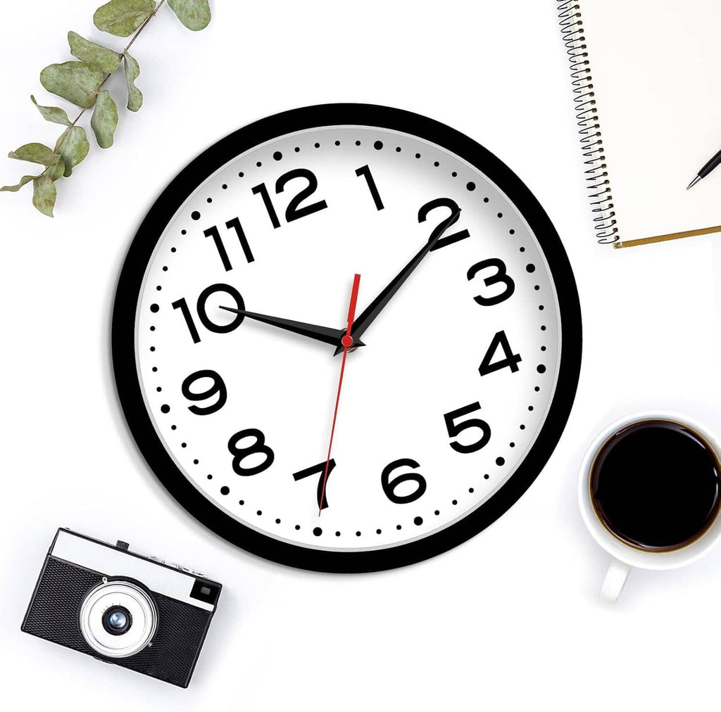 Black-framed wall clock with white dial, large numerals, dotted markers, and red second hand