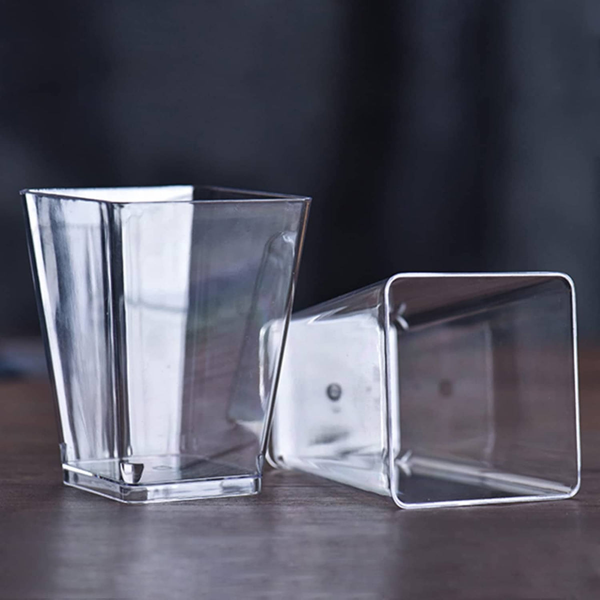 Clear square plastic cups with flat base, two cups shown side by side