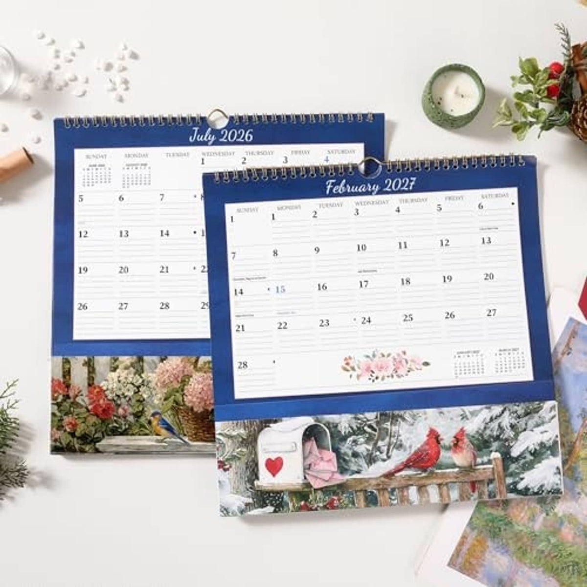 Blue wall calendar with pocket, showing July 2026 and February 2027 pages with florals