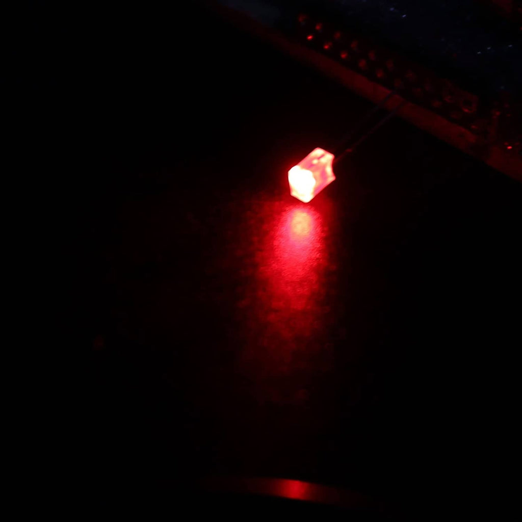 Glowing red LED lamp bulb with two metal leads, bright red light