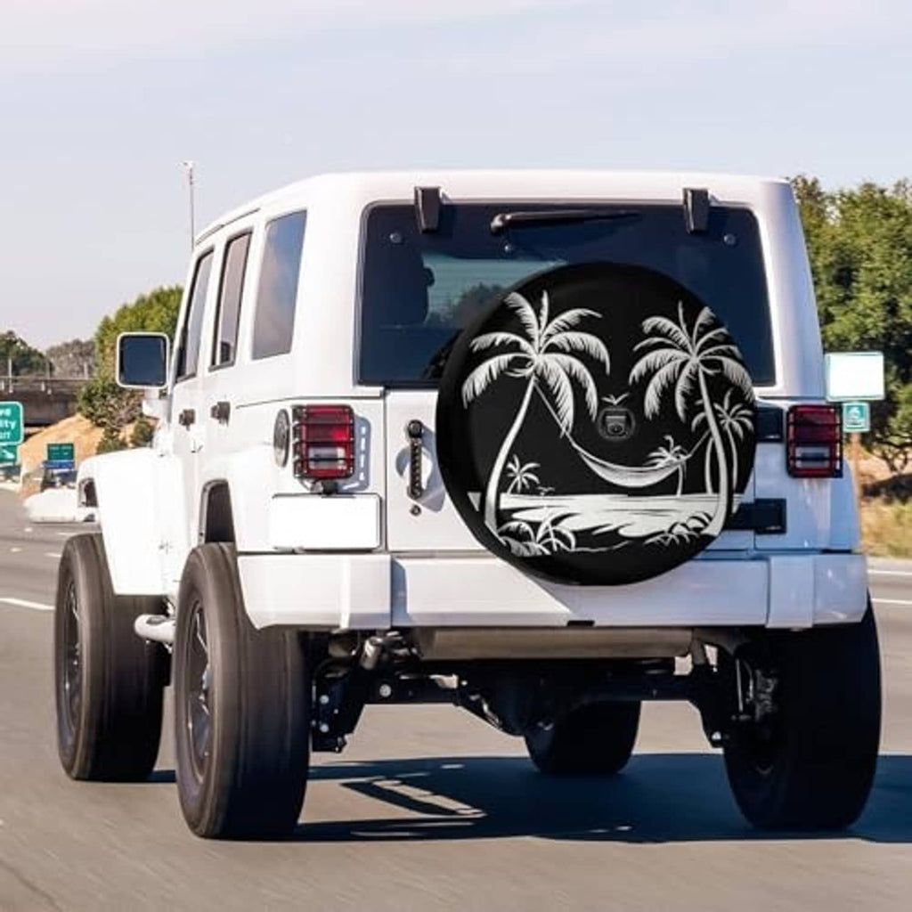 Black spare tire cover with white palm tree graphic and circular camera access