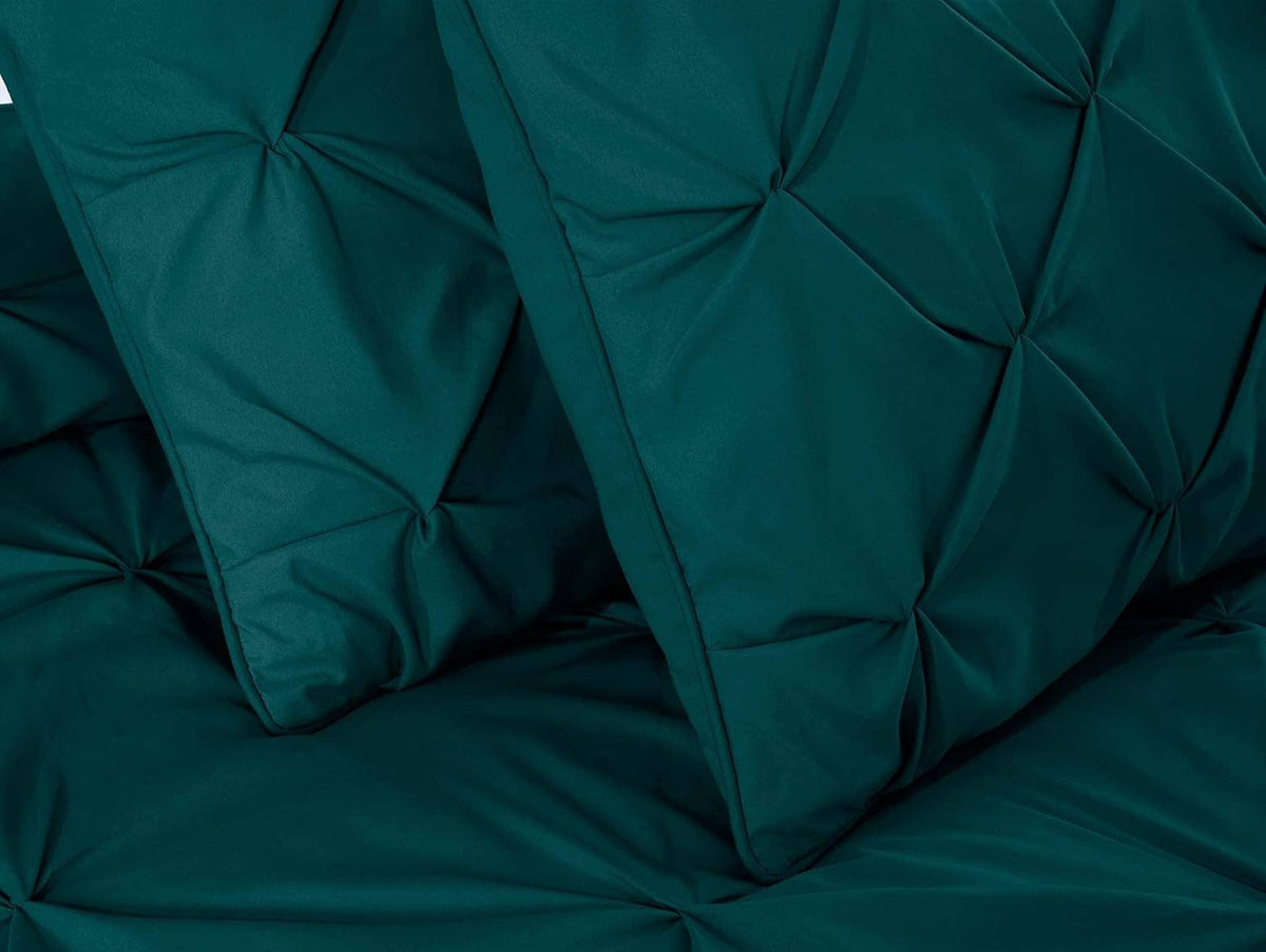 Teal comforter detail with diamond tufted quilting and stitched channel seams
