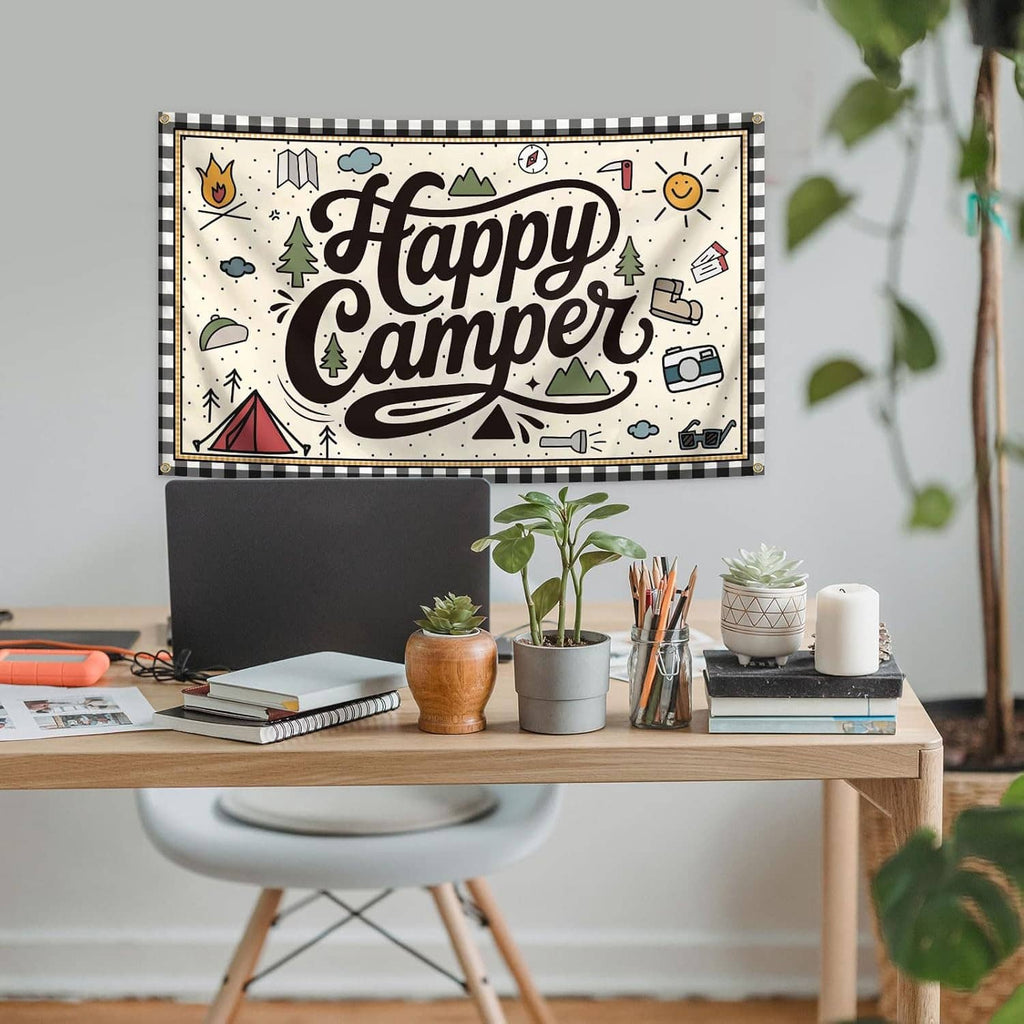 “Happy Camper” camping banner flag with camping icons and brass grommets on wall above desk